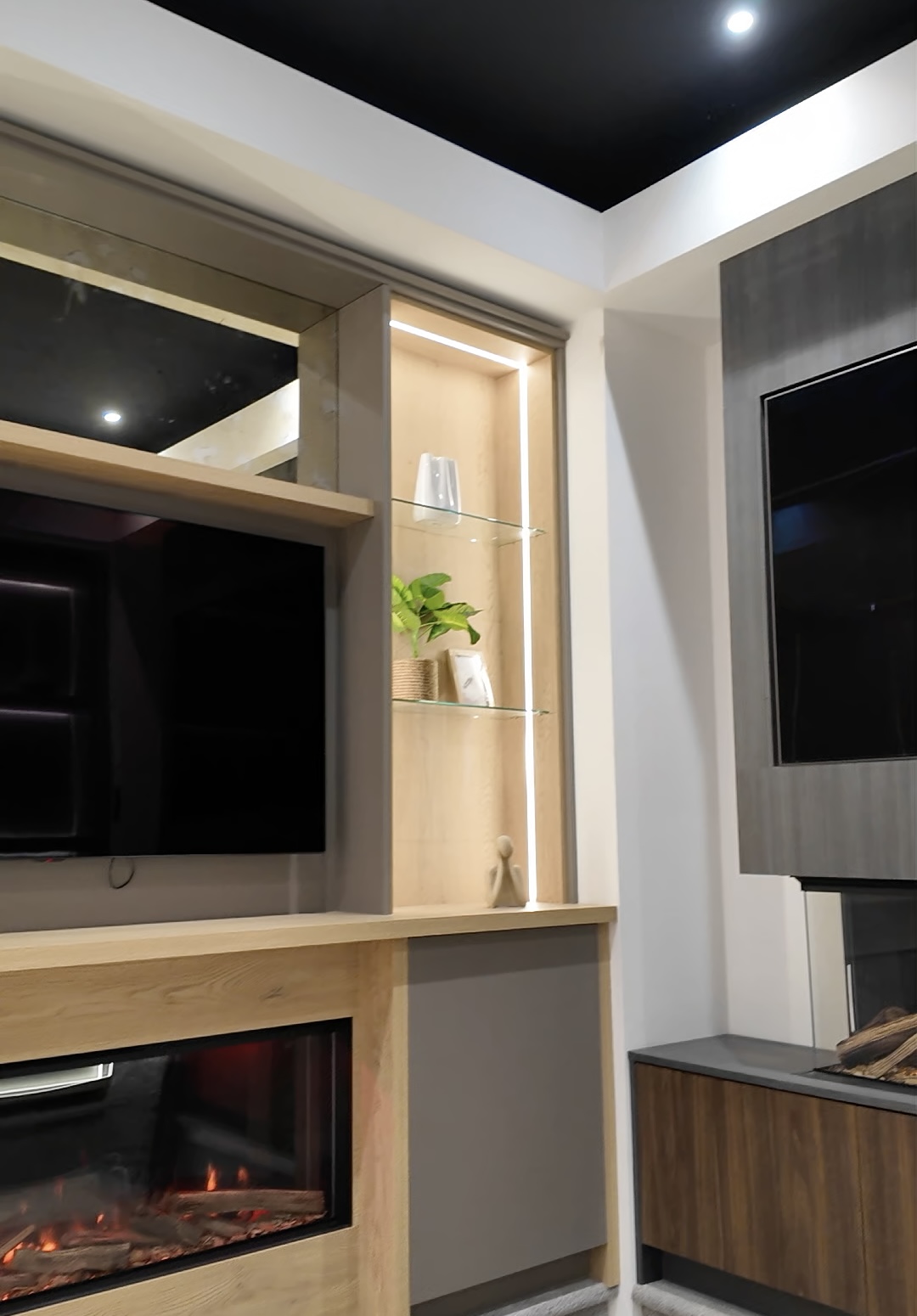 Inside the new Media Wall Co showroom, bespoke media walls in oak and stone with LED-lit display shelving
