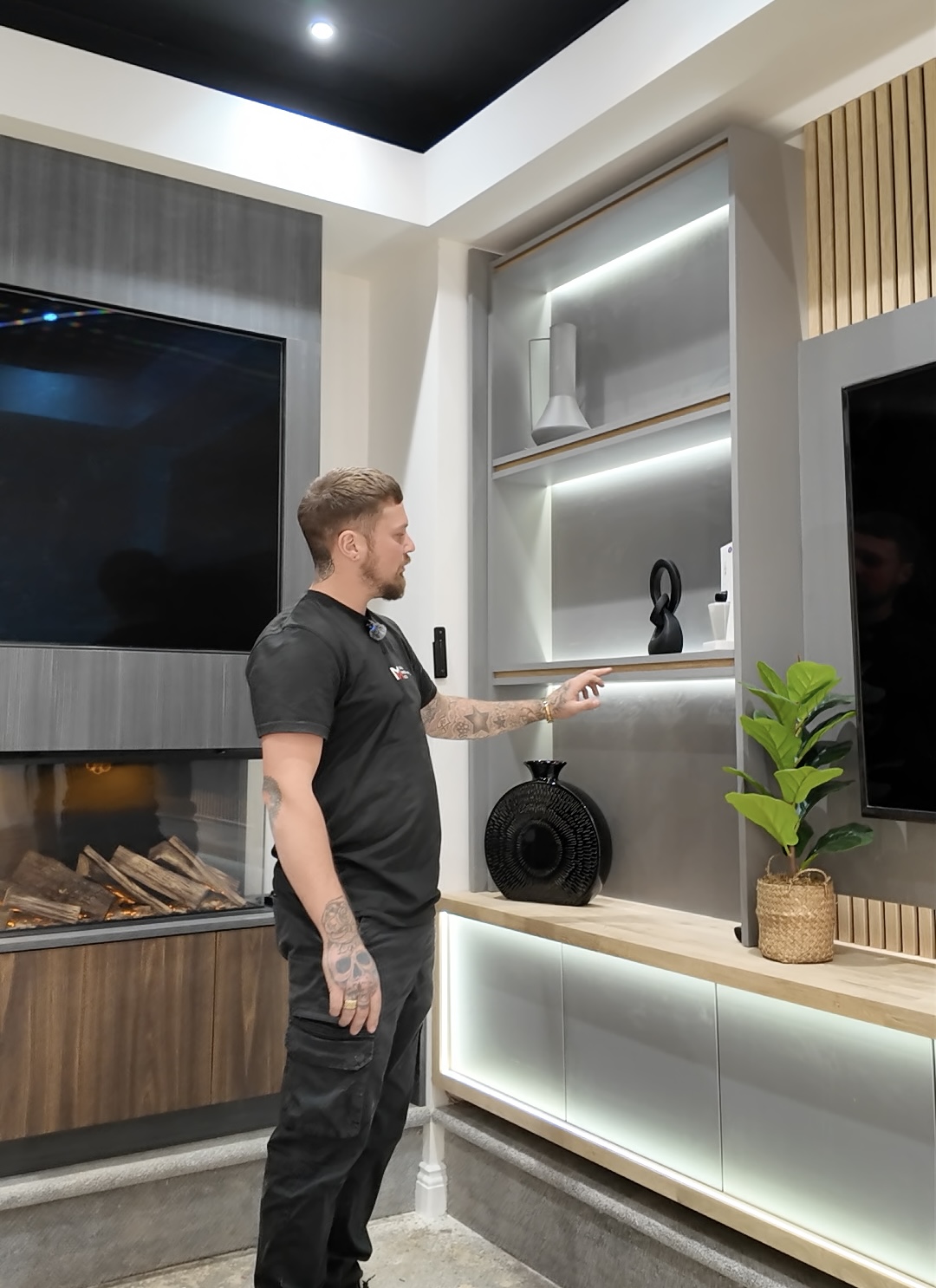 A Media Wall Co designer walking through a bespoke media wall display in the new showroom