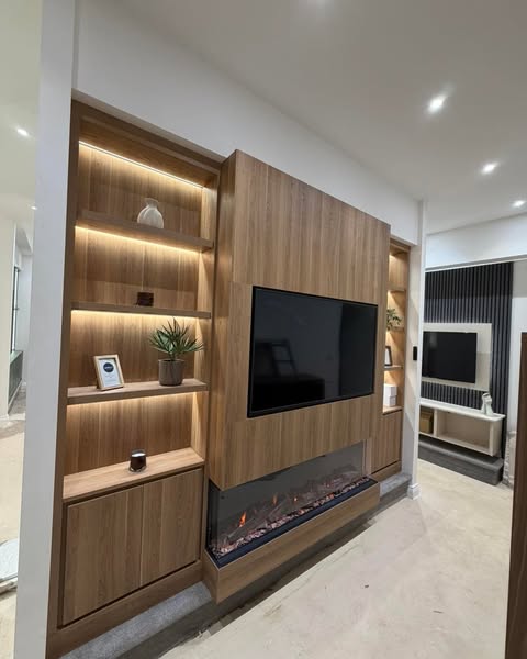 Walnut media wall with LED-lit shelving and a wide electric fire in the new Media Wall Co showroom